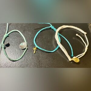 Set of 3 Pura Vida bracelets. 2 with charms